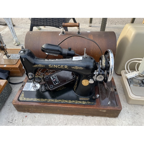 1882 - AN ELECTRIC SINGER SEWING MACHINE WITH FOOT PEDAL AND WOODEN CARRY CASE