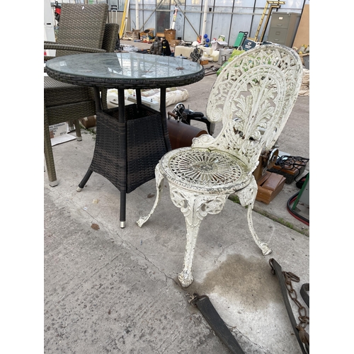 2021 - A ROUND GLASS TOPPED BISTRO TABLE, A CAST ALLOY BISTRO CHAIR AND TWO RATTAN GARDEN CHAIRS