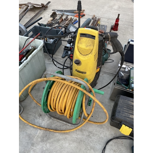 2124 - A HOSE REEL AND AN ELECTRIC CHAMPION PRESSURE WASHER