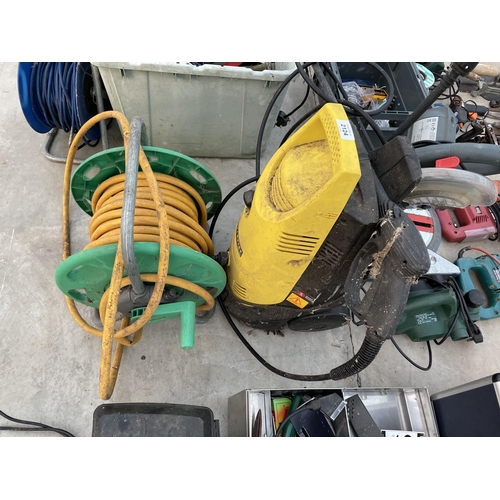 2124 - A HOSE REEL AND AN ELECTRIC CHAMPION PRESSURE WASHER