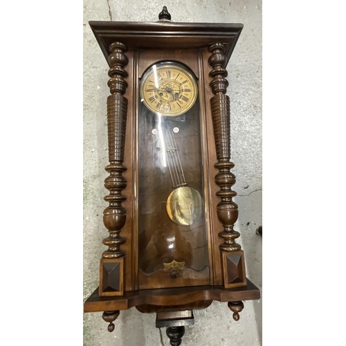 100 - A CARVED WALNUT VIENNA WALL CLOCK WITH ROMAN NUMERALS AND PENDULUM