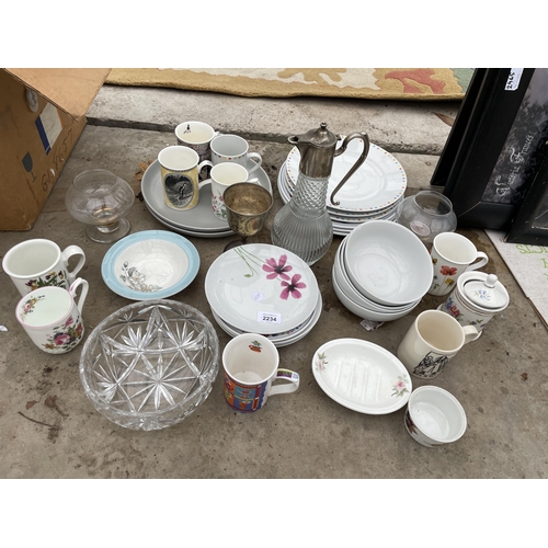 2234 - AN ASSORTMENT OF CERAMIC AND GLASS WARE TO INCLUDE CUPS AND A CLARET JUG ETC