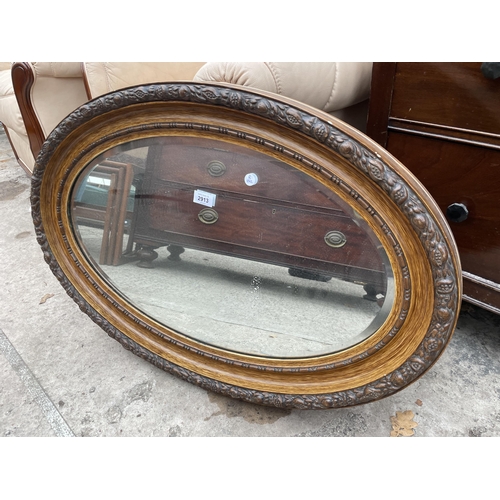 2913 - AN OVAL EDWARDIAN WALL MIRROR