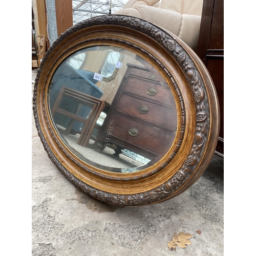 2913 - AN OVAL EDWARDIAN WALL MIRROR