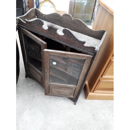 2923 - A LATE VICTORIAN OAK GLAZED TWO DOOR SMOKERS CABINET ENCLOSING SEVEN DRAWERS AND TWO PIPE RACKS, 21.... 