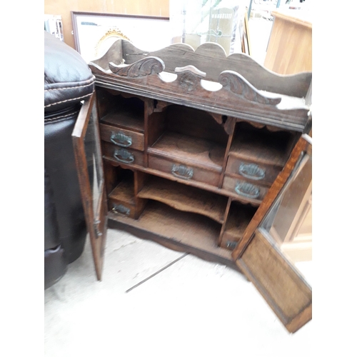 2923 - A LATE VICTORIAN OAK GLAZED TWO DOOR SMOKERS CABINET ENCLOSING SEVEN DRAWERS AND TWO PIPE RACKS, 21.... 