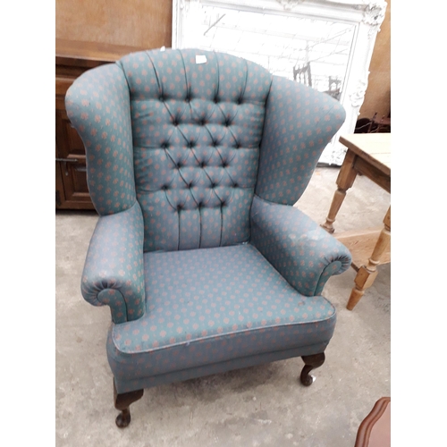 2929 - A MODERN UPHOLSTERED WINGED FIRESIDE CHAIR ON FRONT CABRIOLE LEGS