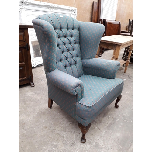 2929 - A MODERN UPHOLSTERED WINGED FIRESIDE CHAIR ON FRONT CABRIOLE LEGS