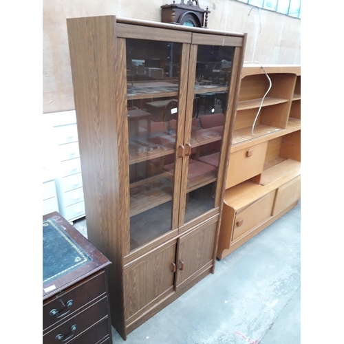 2939 - A MODERN OAK EFFECT TWO DOOR GLAZED BOOKCASE WITH CUPBOARDS TO THE BASE, 36