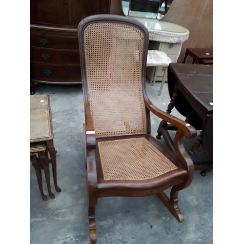 2951 - A VICTORIAN ROCKING CHAIR WITH SPLIT CANE SEAT AND BACK