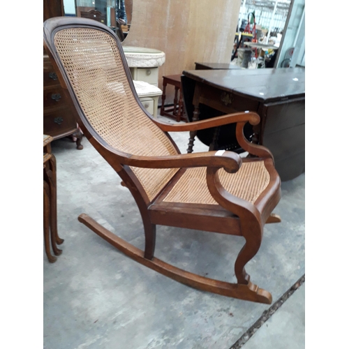 2951 - A VICTORIAN ROCKING CHAIR WITH SPLIT CANE SEAT AND BACK