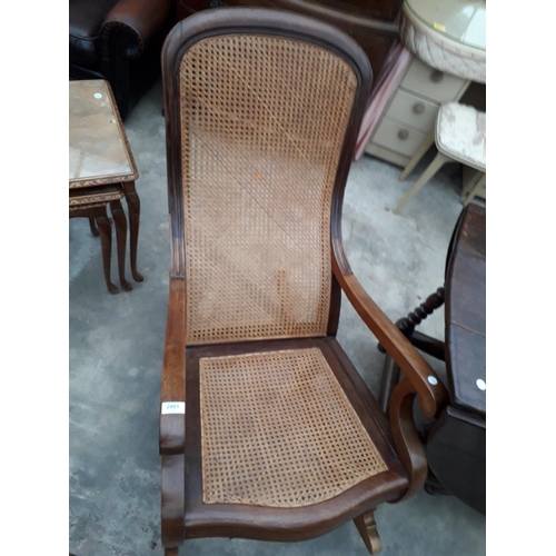 2951 - A VICTORIAN ROCKING CHAIR WITH SPLIT CANE SEAT AND BACK