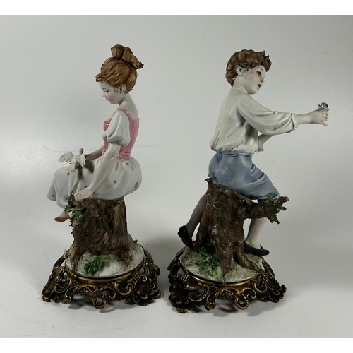 120 - A PAIR OF CONTINENTAL PORCELAIN FIGURES OF A BOY AND GIRL ON GILT METAL BASES