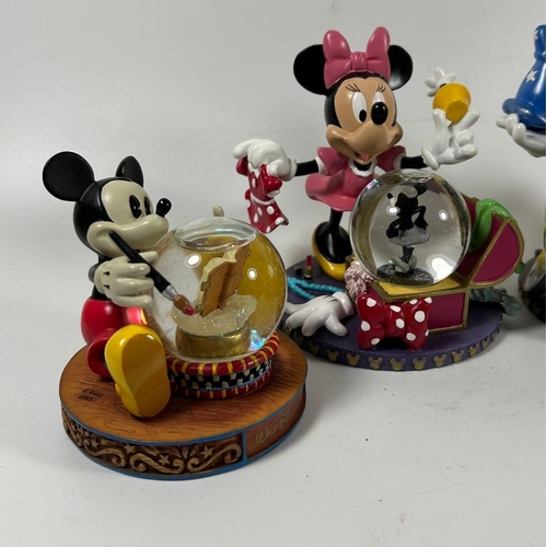 81 - A GROUP OF FOUR DISNEY COLLECTABLE SNOWGLOBES, PLANE CRAZY, 2007 ETC