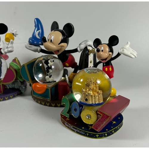 81 - A GROUP OF FOUR DISNEY COLLECTABLE SNOWGLOBES, PLANE CRAZY, 2007 ETC