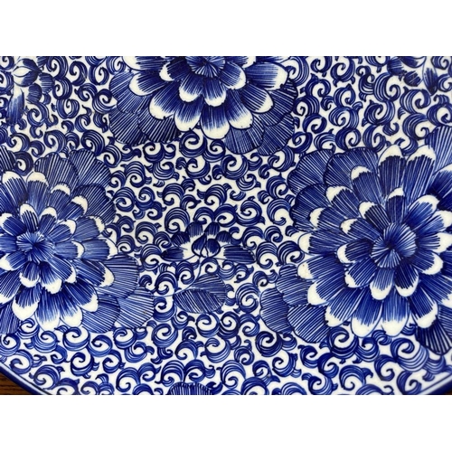 310A - A JAPANESE BLUE AND WHITE POTTERY CHRYSANTHEMUM DESIGN FLORAL CHARGER PLATE, DIAMETER 46CM