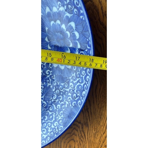 310A - A JAPANESE BLUE AND WHITE POTTERY CHRYSANTHEMUM DESIGN FLORAL CHARGER PLATE, DIAMETER 46CM