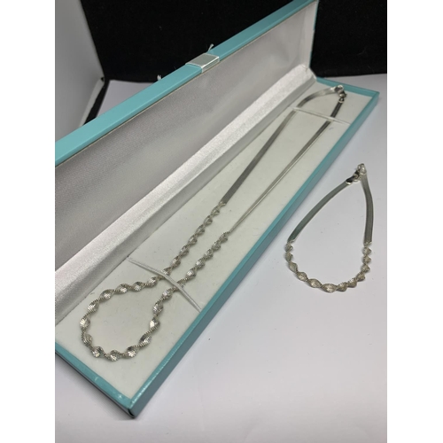 20 - A BOXED SILVER NECKLACE AND BRACELET