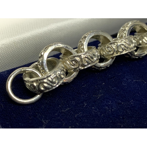 22 - A BOXED SILVER ROLLER BALL ORNATE BRACELET