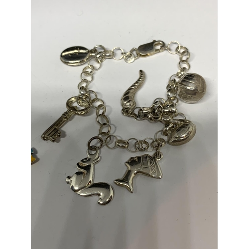 43 - THREE SILVER CHARM BRACELETS