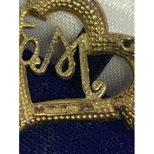 44 - A SILVER AND GOLD MOTHER BROOCH