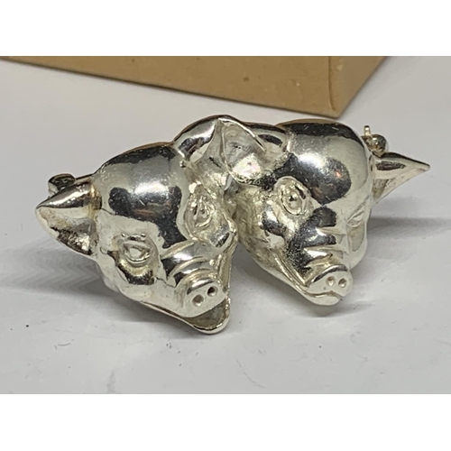 49 - A BOXED SILVER PIGS HEAD BROOCH