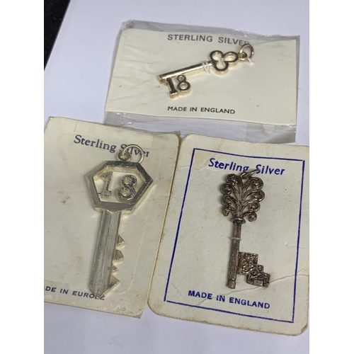 83 - A BAG OF SILVER KEY CHARMS