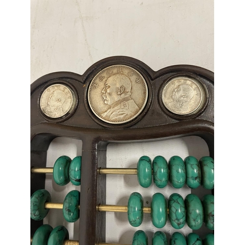 137 - A CHINESE ABACUS WITH MALACHITE COUNTERS AND SILVER COINS