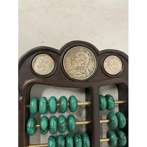 137 - A CHINESE ABACUS WITH MALACHITE COUNTERS AND SILVER COINS