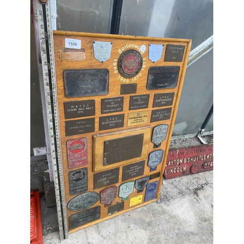 1506 - A WOODEN BOARD DISPLAYING A LARGE QUANTITY OF COMMEMERATIVE BRASS PLAQUES FROM VARIOUS STEAM RALLIES