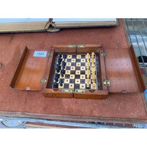 1584 - A VINTAGE MAHOGANY FOLDING TRAVEL CHESS SET WITH BRASS HINGES AND CLASPS