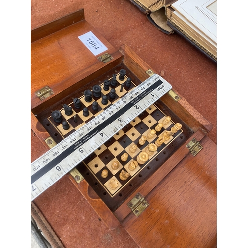 1584 - A VINTAGE MAHOGANY FOLDING TRAVEL CHESS SET WITH BRASS HINGES AND CLASPS