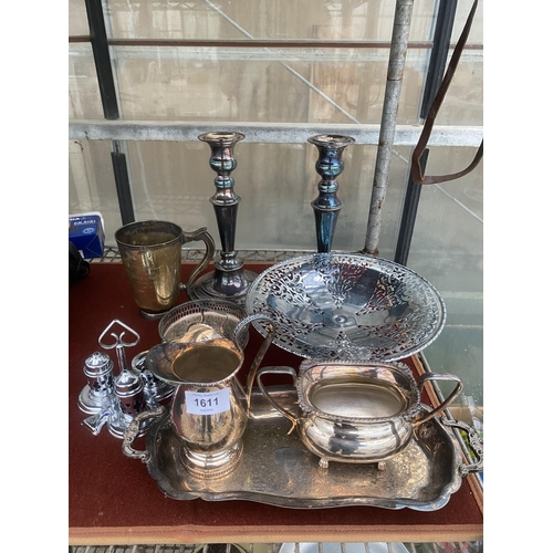 1611 - AN ASSORTMENT OF SILVER PLATED ITEMS TO INCLUDE A PAIR OF CANDLESTICKS, A TWIN HANDLED TRAY AND A CR... 