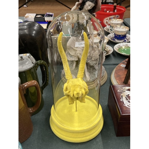 131 - A YELLOW ANIMAL SKULL IN A GLASS DOME