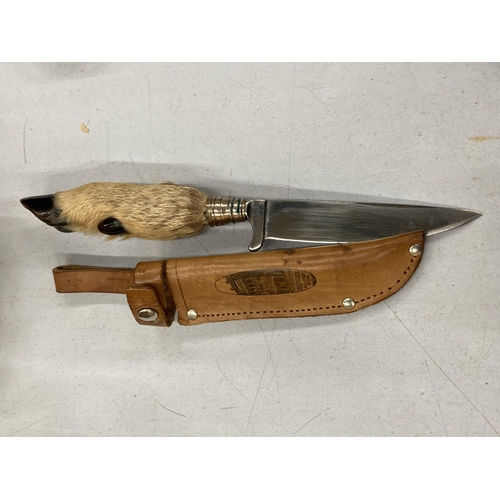 156 - A HUNTING KNIFE WITH A DEER FOOT AHNDLE IN A LEATHER CASE