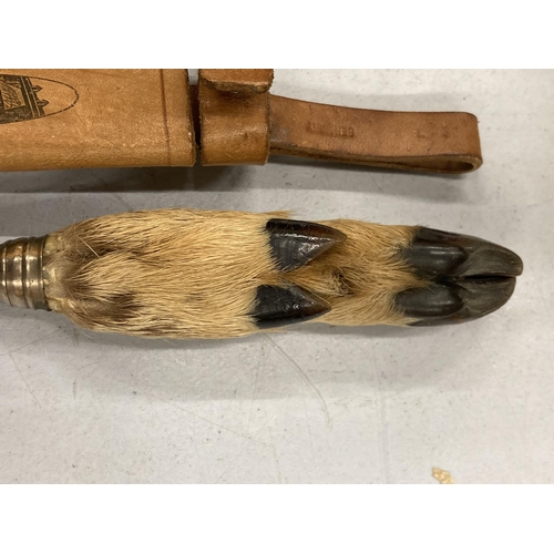 156 - A HUNTING KNIFE WITH A DEER FOOT AHNDLE IN A LEATHER CASE