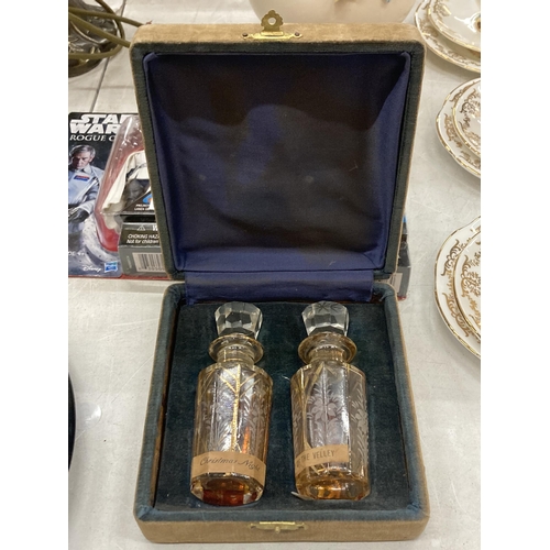 183 - TWO VINTAGE GLASS PERFUME BOTTLES WITH STOPPERS IN THE ORIGINAL CASE