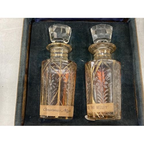 183 - TWO VINTAGE GLASS PERFUME BOTTLES WITH STOPPERS IN THE ORIGINAL CASE