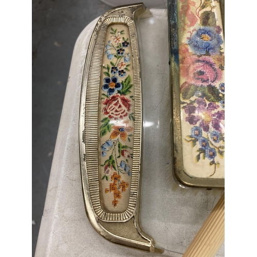 193 - A VINTAGE PETIT-POINT BRUSH AND MIRROR SET ON A GLASS TRAY