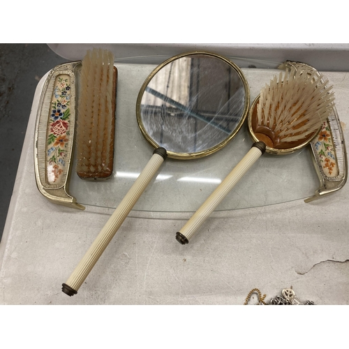 193 - A VINTAGE PETIT-POINT BRUSH AND MIRROR SET ON A GLASS TRAY