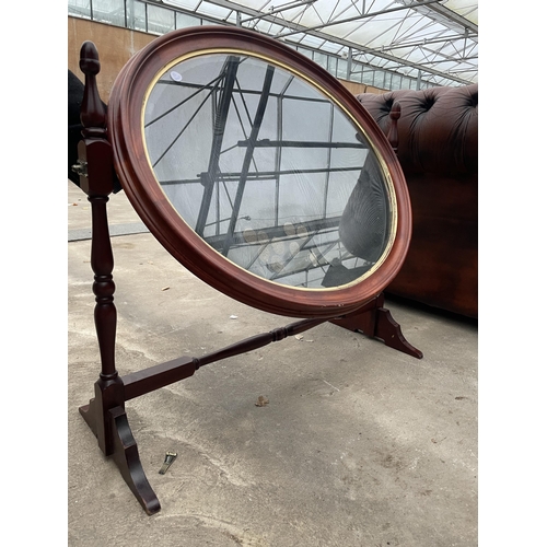 2689 - A MODERN OVAL SWING FRAME DISPLAY UNIT WITH TURNED UPRIGHTS