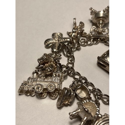 122 - A SILVER CHARM BRACELET WITH FOURTEEN CHARMS