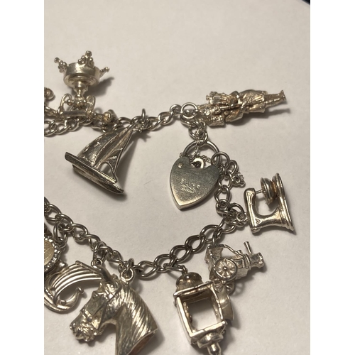 122 - A SILVER CHARM BRACELET WITH FOURTEEN CHARMS