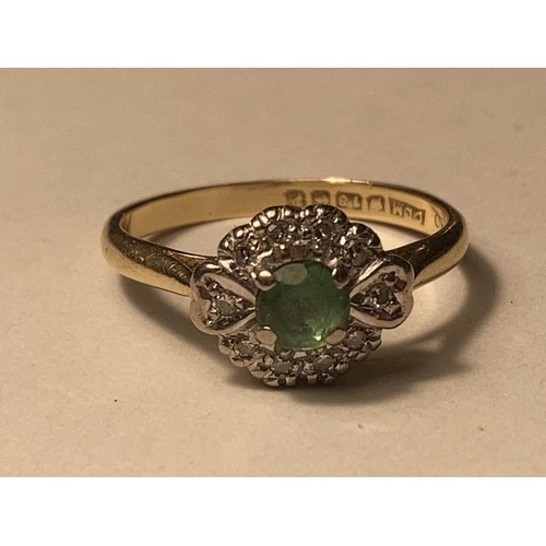 162 - AN 18 CARAT GOLD RING WITH CENTRE EMERALD SURROUNDED BY DIAMONDS SIZE M/N