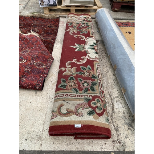 2482 - A LARGE RED PATTERNED RUG