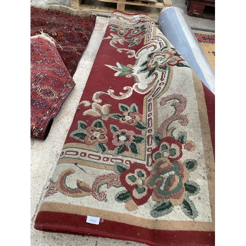 2482 - A LARGE RED PATTERNED RUG