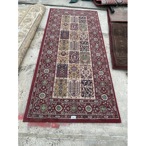 2486 - A SMALL RED PATTERNED RUG