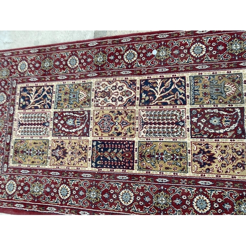 2486 - A SMALL RED PATTERNED RUG