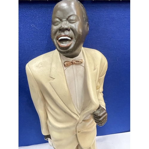 18 - A HEAVY LOUIS ARMSTRONG FIGURE WITH TRUMPET AND MICROPHONE 22 INCHES TALL