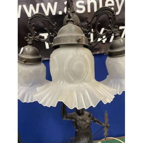 26 - A BRONZE EFFECT LADY LAMP WITH THREE GLASS SHADES